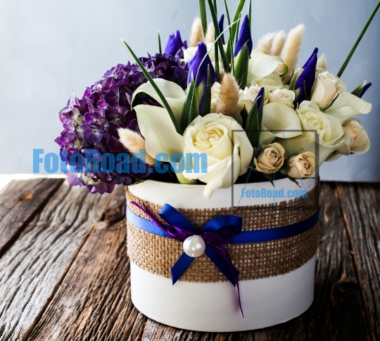 Beautiful flower composition on rustic wooden table