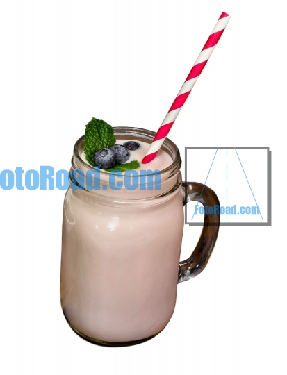 Blueberry milk shake in glass with straw on white background
