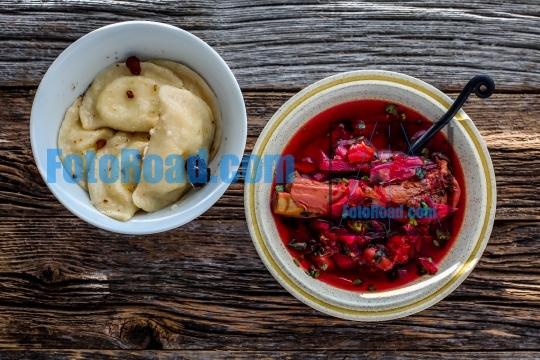 Borscht soup with ribs and dumplings on rustic table