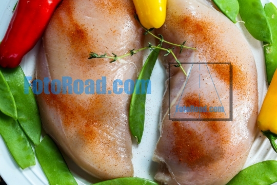 Chicken breast with ingredients on plate