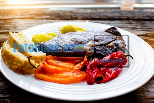 Club steak with grilled   sweet peppers on plate 