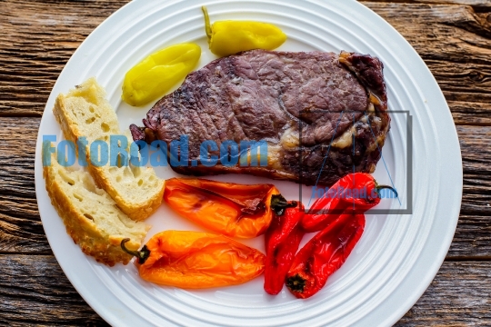 Club steak with grilled sweet peppers