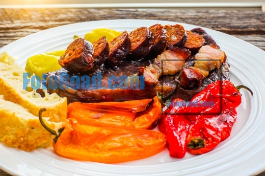 Club steak with home made grilled sausages and sweet peppers on 