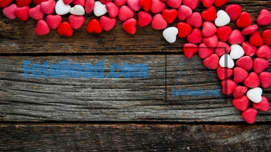 Colorful candy hearts  background with copy space on rustic wood