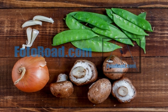 Cooking vegetables ingredients on rustic wooden background