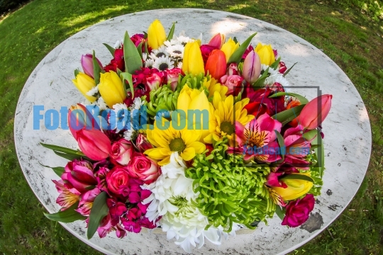 Flowers bouquet outdoor on white table with wide angle lens