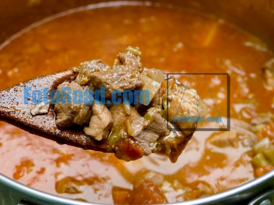 Goulash pork and beef meat on wooden spoon