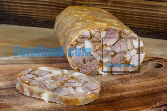 Home made head cheese on wooden background