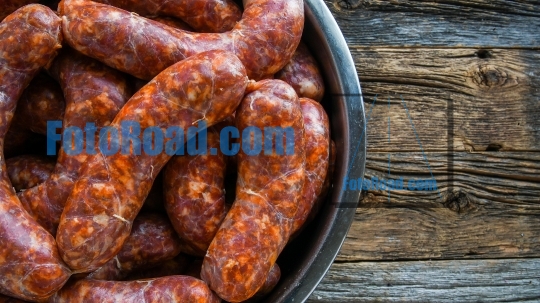 Home made sausages on rustic wooden background  
