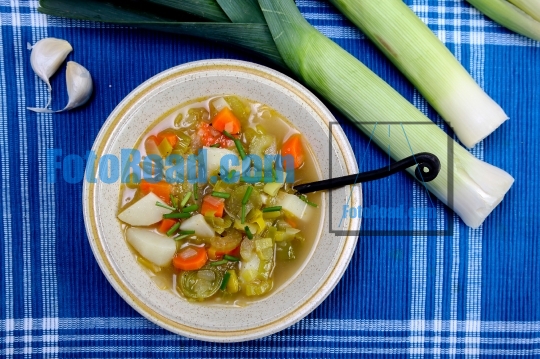 Leek soup with potato on blue background