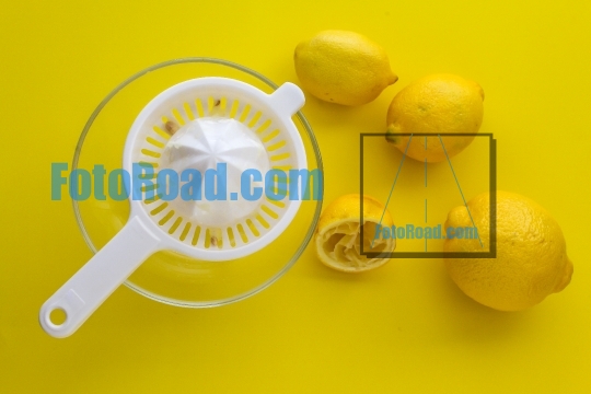 Lemons on yellow table ready for squeezing top view