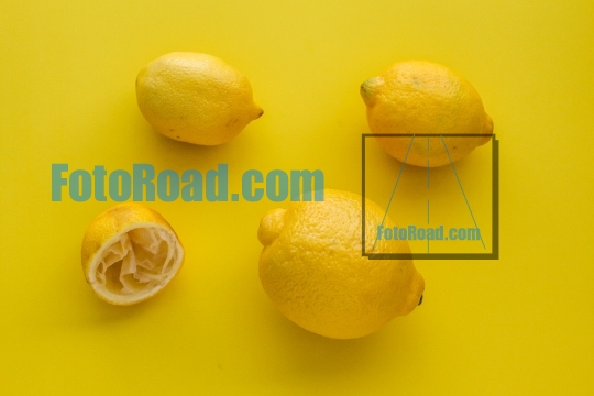 Lemons on yellow table ready for top view