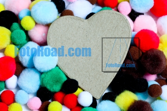 Miuticolored pom-poms with paper heart