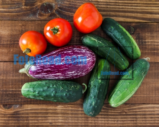 Mixed fresh vegetables from garden on wooden background