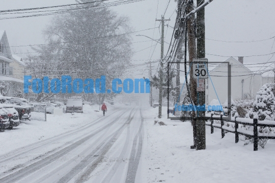 Person is walking in snow storm  day on street