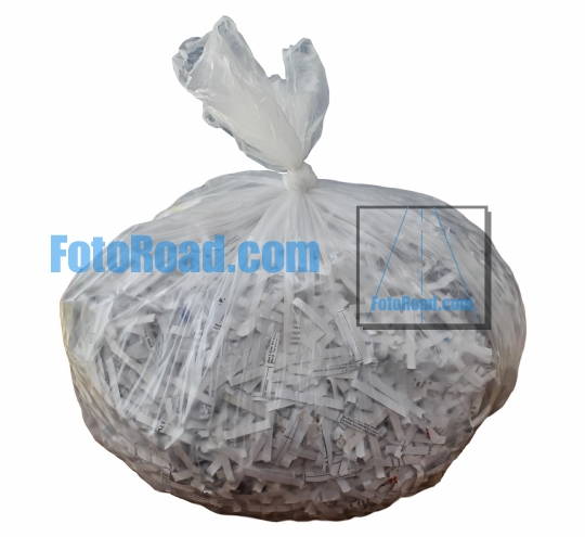 Plastic bag with shredded paper inside plastic bag isolated on w