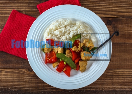 Plate with chicken, rice and vegetables directly from above