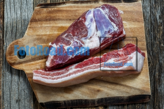Pork belly meat on wooden cut board