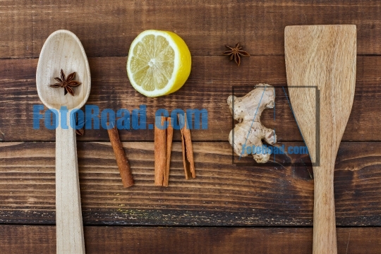 Rustic table top view with wooden spoons and tea ingredients