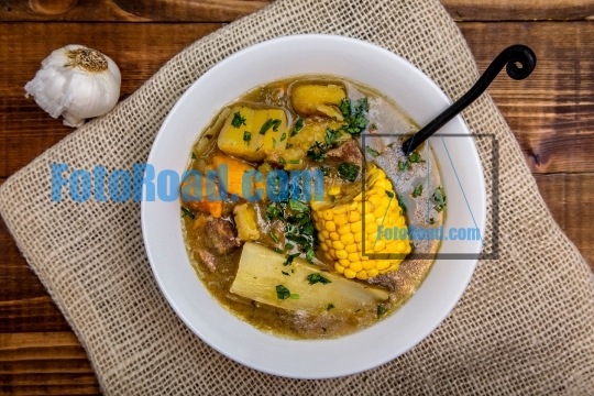 Sancocho - puerto rican beef stew on wooden table top view