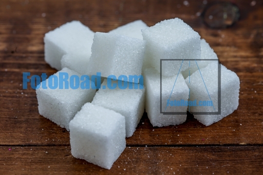 Sugar cubes on wooden rustic background