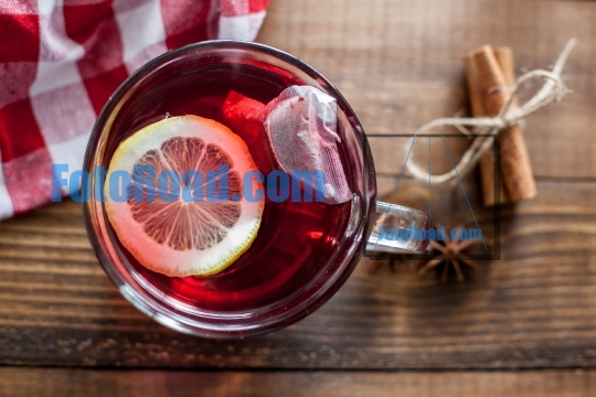 Tea on table with lemon, cinamon and anise on wooden background 