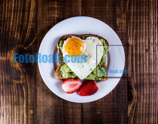 Toast with avocado and egg in heart shape
