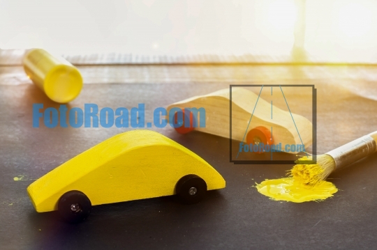 Toy cars with yellow paint brush and sunbeam