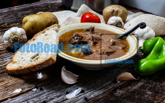 Traditional Slovak beef stew on rustic wooden table