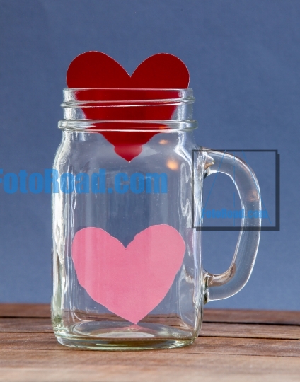 Two paper hearts inside  jar