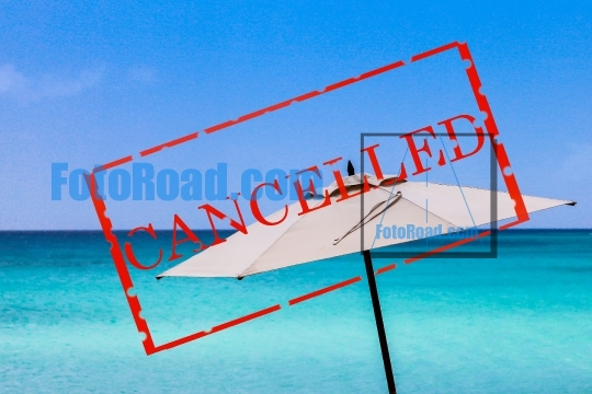 Umbrella with blue sky and ocean and text cancelled