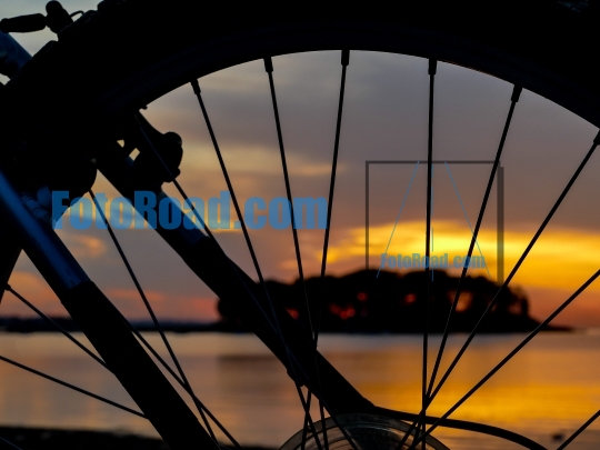 Wheel silhouette from bike and sunrise light 