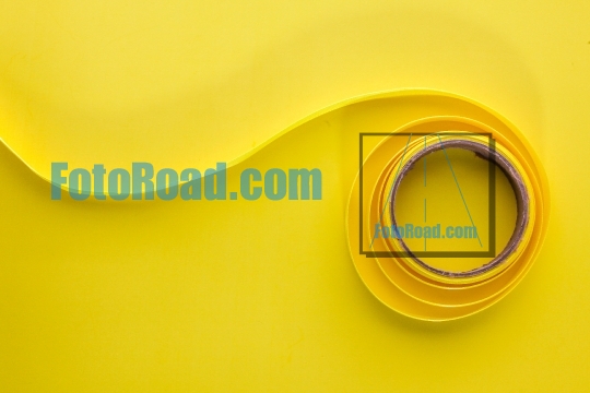 Yellow  ribbon on yellow background table top