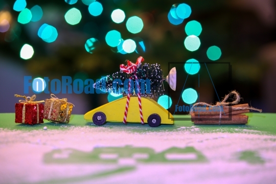 Yellow car with Christmas tree, decoration and lights