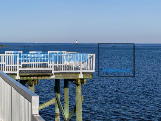 Fishing pier with blue ocean and blue sky