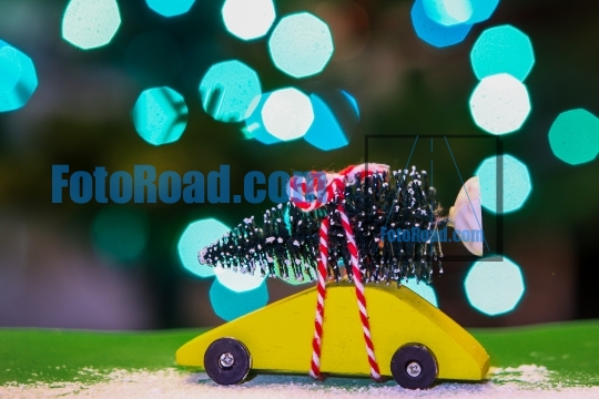 Yellow car with Christmas tree and lights